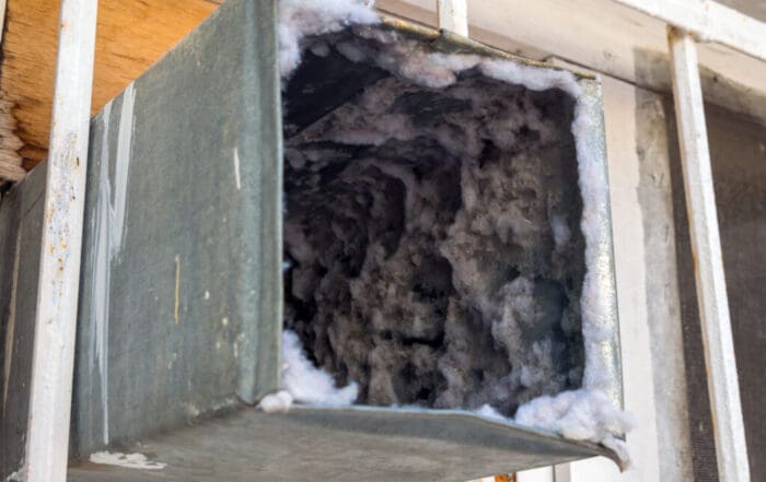 Old air duct filled with dust and dirt causing efficiency problems and potential health issues